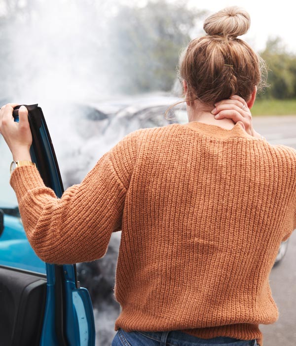 person holding neck after car accident